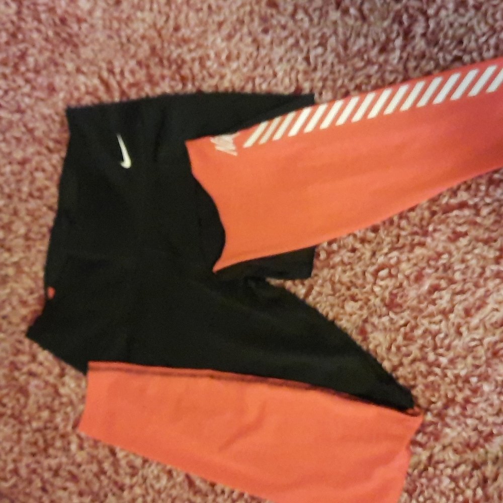 Nike leggings.  Mesh bottom from the knee down. Size small. Black and a pink.